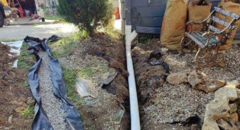 Photo of a yard drainage solution being installed | YARD GRADING AND DRAINAGE SOLUTIONS | DRY BASEMENT®